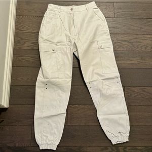 White leather cargo pants cinched at ankles